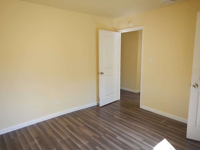 7121 Conley St, Houston, TX 77021 - empty room with baseboards and dark wood-style floors