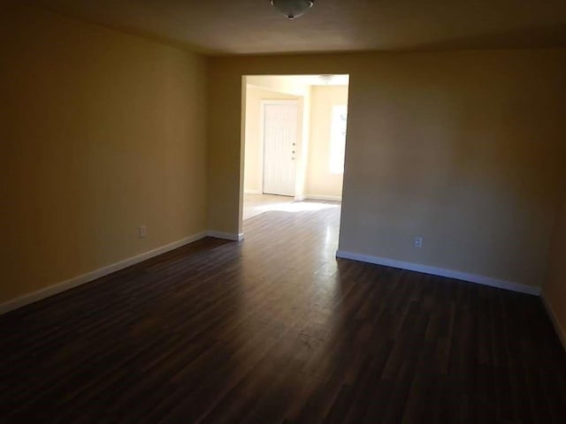 7121 Conley St, Houston, TX 77021 - spare room featuring baseboards and dark wood-style floors