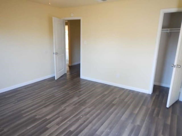 7121 Conley St, Houston, TX 77021 - unfurnished bedroom with dark wood finished floors and a closet