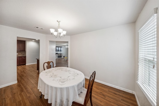 16743 Fallen Timbers Dr, Conroe, TX 77385 - dining space with dark wood-type flooring, a chandelier, and healthy amount of natural light