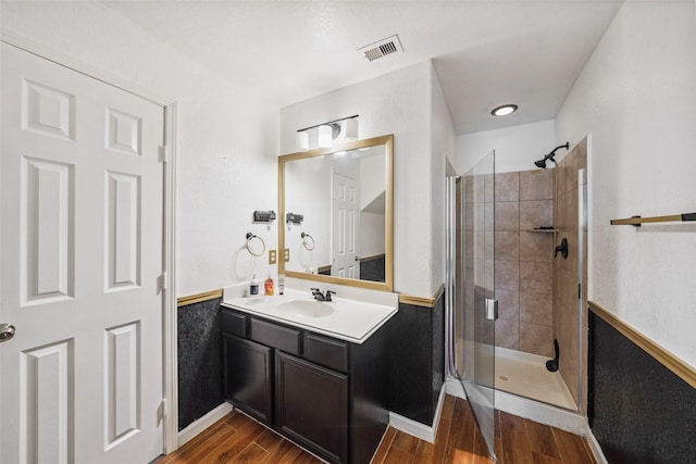 16743 Fallen Timbers Dr, Conroe, TX 77385 - full bath with a shower stall, wood finished floors, vanity, and a wainscoted wall