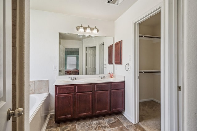 16743 Fallen Timbers Dr, Conroe, TX 77385 - full bath with double vanity, a bath, and a spacious closet