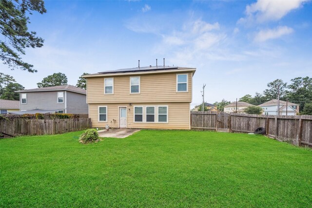 16743 Fallen Timbers Dr, Conroe, TX 77385 - rear view of property featuring a patio, solar panels, and a fenced backyard