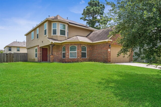 16743 Fallen Timbers Dr, Conroe, TX 77385 - view of front of home featuring brick siding, roof mounted solar panels, an attached garage, and driveway