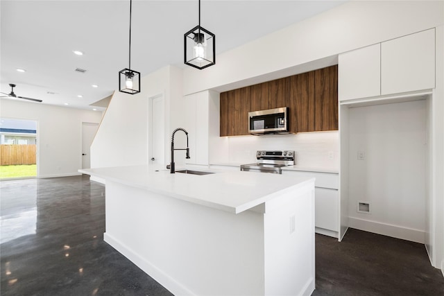 8205 Parnell St, Houston, TX 77051 - kitchen featuring appliances with stainless steel finishes, modern cabinets, white cabinetry, finished concrete floors, and ceiling fan