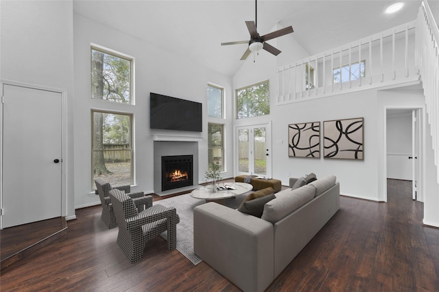 12319 Hamsfield Ct, Tomball, TX 77377 - living room with high vaulted ceiling, a lit fireplace, ceiling fan, and plenty of natural light