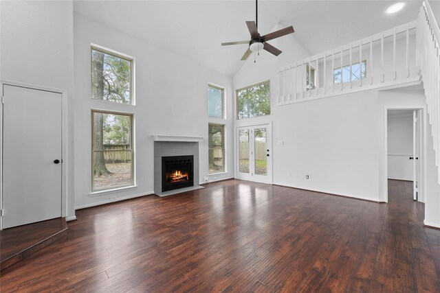 12319 Hamsfield Ct, Tomball, TX 77377 - unfurnished living room featuring high vaulted ceiling, a fireplace with flush hearth, a ceiling fan, and plenty of natural light