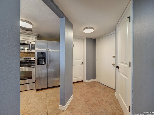 15002 Windward Dr Unit 207, Corpus Christi, TX 78418 - kitchen with stainless steel appliances and light tile patterned floors