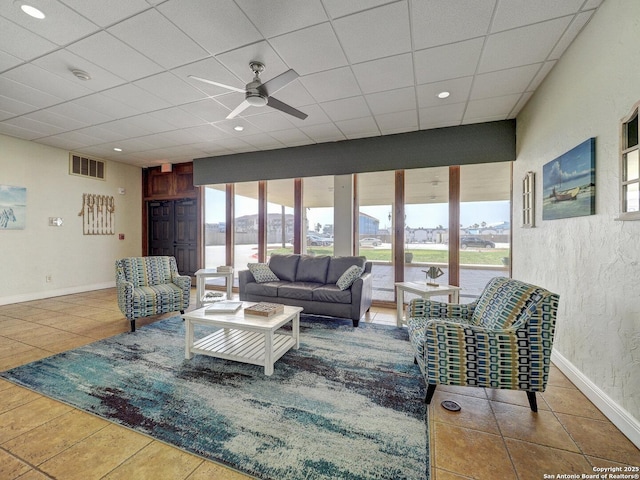 15002 Windward Dr Unit 207, Corpus Christi, TX 78418 - living area featuring healthy amount of natural light, a ceiling fan, tile patterned floors, a paneled ceiling, and a textured wall