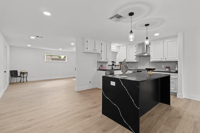 806 Lyngrove Dr, Houston, TX 77038 - kitchen featuring dark countertops, recessed lighting, wall chimney range hood, white cabinets, and a kitchen island