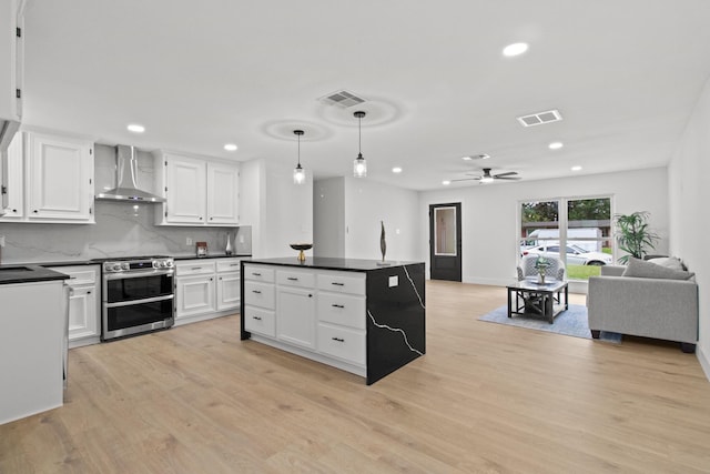 806 Lyngrove Dr, Houston, TX 77038 - kitchen with double oven range, wall chimney exhaust hood, dark countertops, open floor plan, and white cabinets