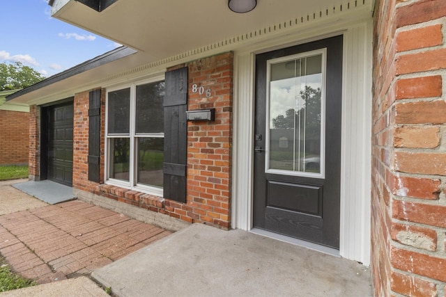 806 Lyngrove Dr, Houston, TX 77038 - doorway to property featuring brick siding and a porch
