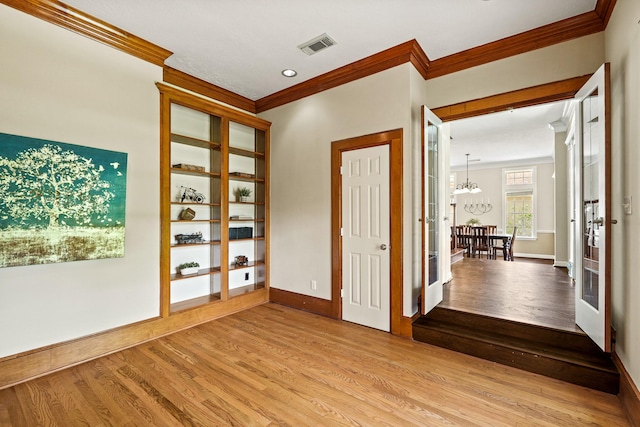 33318 Winsford St, Fulshear, TX 77441 - spare room featuring crown molding, wood finished floors, and a chandelier