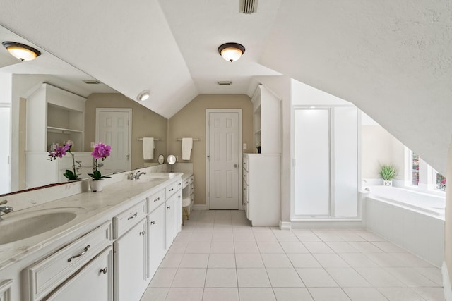 33318 Winsford St, Fulshear, TX 77441 - full bathroom with double vanity, a bath, tile patterned floors, vaulted ceiling, and a closet