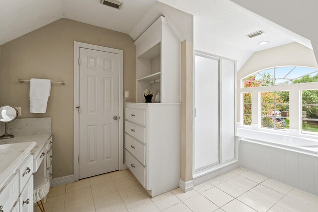 33318 Winsford St, Fulshear, TX 77441 - full bathroom featuring lofted ceiling, tile patterned floors, vanity, a closet, and tiled tub