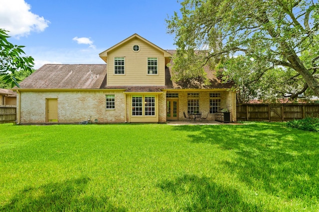 33318 Winsford St, Fulshear, TX 77441 - rear view of property with brick siding, a fenced backyard, roof with shingles, a patio, and french doors