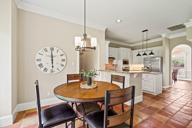 33318 Winsford St, Fulshear, TX 77441 - dining room with crown molding, a chandelier, recessed lighting, light tile patterned flooring, and arched walkways