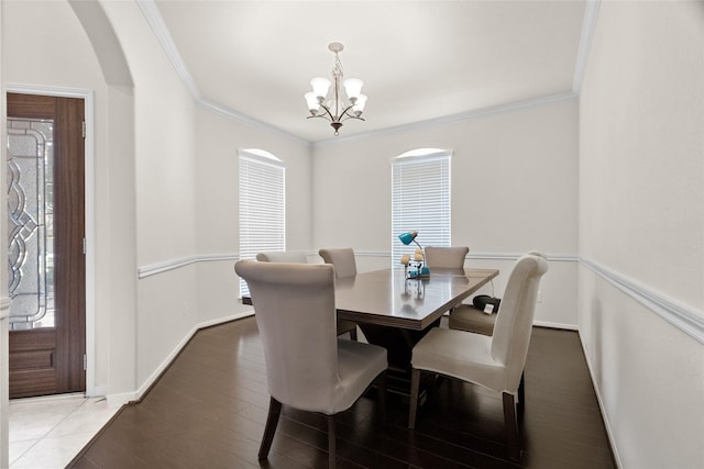 3922 Crestwind Ln, Richmond, TX 77407 - dining space with a chandelier, crown molding, arched walkways, and wood finished floors
