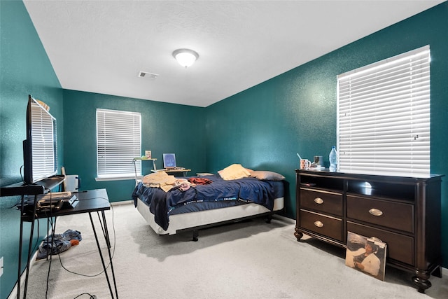3922 Crestwind Ln, Richmond, TX 77407 - bedroom featuring light carpet and a textured wall