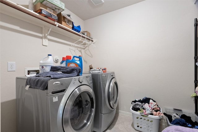 3922 Crestwind Ln, Richmond, TX 77407 - washroom with washing machine and dryer and light tile patterned flooring