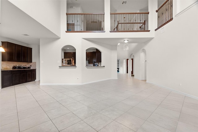3922 Crestwind Ln, Richmond, TX 77407 - unfurnished living room with light tile patterned flooring and a high ceiling
