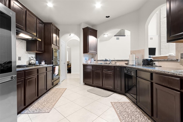3922 Crestwind Ln, Richmond, TX 77407 - kitchen with black appliances, arched walkways, dark brown cabinets, tasteful backsplash, and recessed lighting