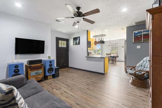 418 E Cedar Bayou Lynchburg Rd, Baytown, TX 77521 - living room featuring light wood-type flooring, ceiling fan, plenty of natural light, recessed lighting, and a textured ceiling