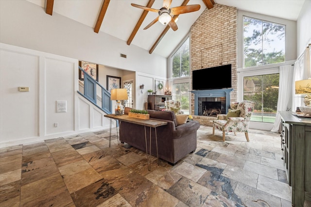 14615 Sunny Grove Dr, Houston, TX 77070 - living room with high vaulted ceiling, a ceiling fan, stone tile floors, beam ceiling, and a fireplace
