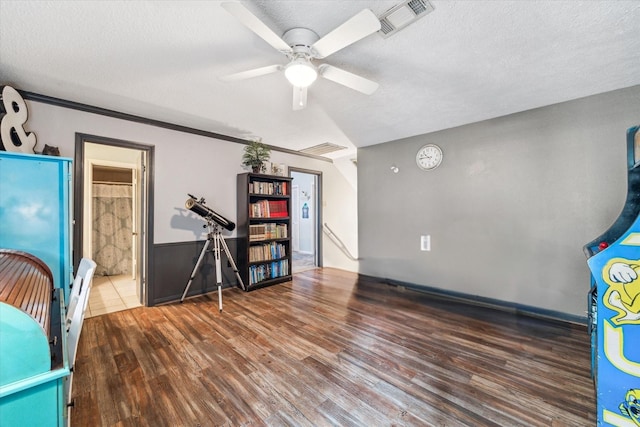 14615 Sunny Grove Dr, Houston, TX 77070 - interior space featuring wood finished floors, a textured ceiling, a ceiling fan, and a wainscoted wall