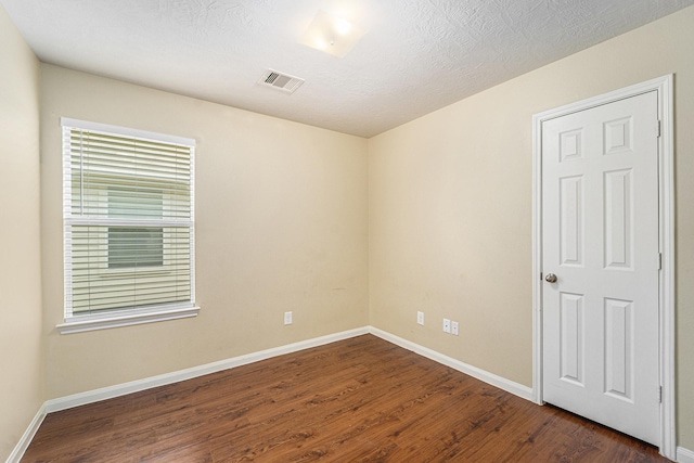 12006 Gregory Crossing Way, Houston, TX 77067 - empty room with dark wood-style flooring and baseboards