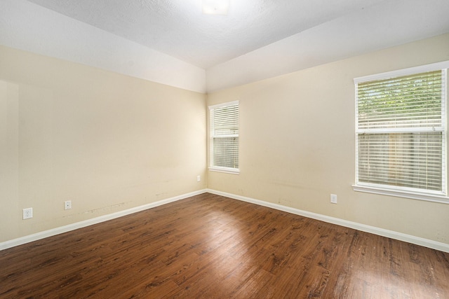12006 Gregory Crossing Way, Houston, TX 77067 - empty room with dark wood finished floors and vaulted ceiling
