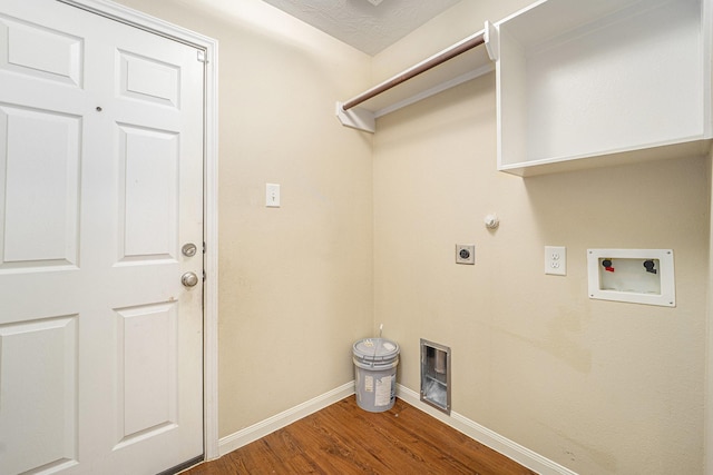 12006 Gregory Crossing Way, Houston, TX 77067 - laundry area featuring hookup for an electric dryer, wood finished floors, washer hookup, and gas dryer hookup
