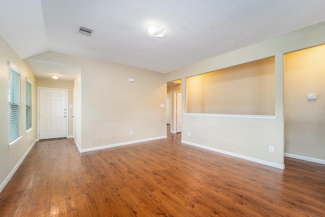 12006 Gregory Crossing Way, Houston, TX 77067 - spare room with wood finished floors and vaulted ceiling