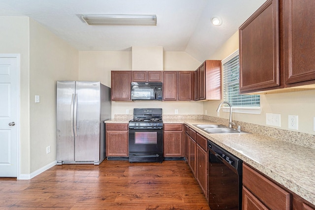 12006 Gregory Crossing Way, Houston, TX 77067 - kitchen featuring black appliances, lofted ceiling, light countertops, and dark wood finished floors