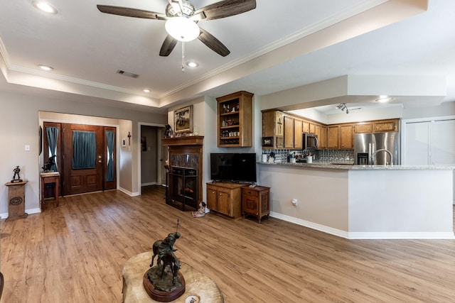 1608 Durham Dr, Huntsville, TX 77340 - living area with light wood-type flooring, a raised ceiling, crown molding, ceiling fan, and recessed lighting
