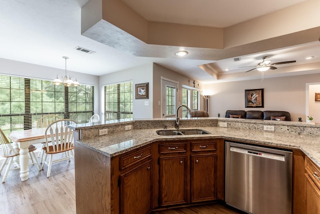 1608 Durham Dr, Huntsville, TX 77340 - kitchen featuring dishwasher, light wood-style flooring, light stone counters, a raised ceiling, and recessed lighting