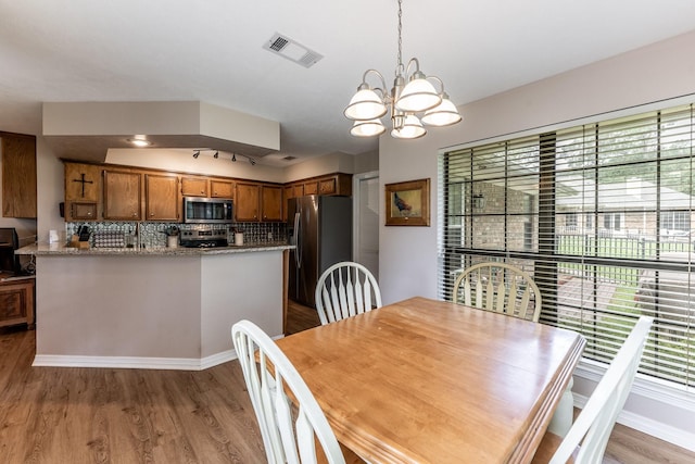 1608 Durham Dr, Huntsville, TX 77340 - dining area featuring light wood-type flooring and a chandelier
