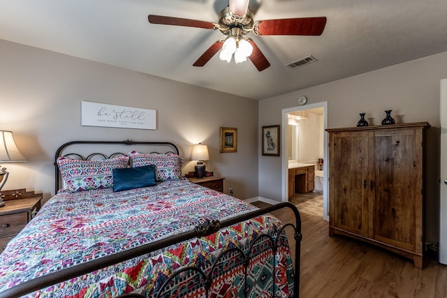 1608 Durham Dr, Huntsville, TX 77340 - bedroom featuring wood finished floors, ceiling fan, and ensuite bathroom