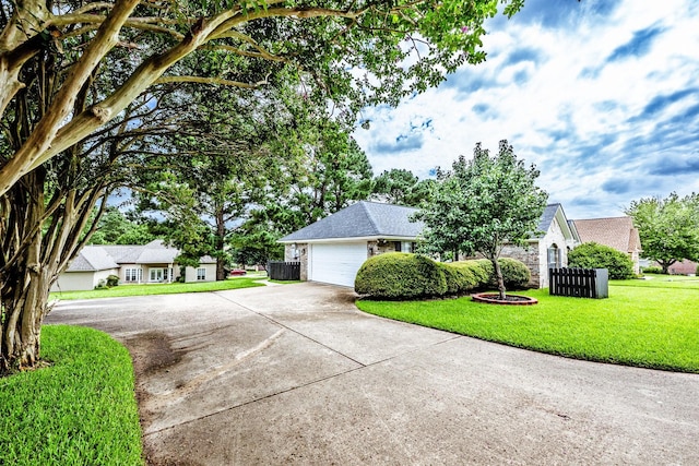 1608 Durham Dr, Huntsville, TX 77340 - view of front facade featuring concrete driveway, a front lawn, a garage, and a residential view