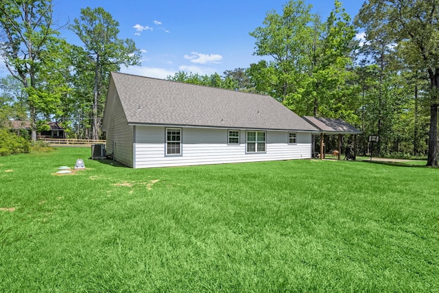 683 Cross Timbers, Livingston, TX 77351 - back of house with a lawn and roof with shingles