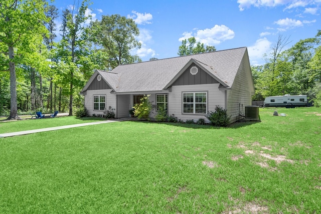 683 Cross Timbers, Livingston, TX 77351 - view of front of property featuring board and batten siding, a front yard, and roof with shingles