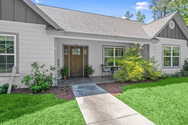683 Cross Timbers, Livingston, TX 77351 - entrance to property with board and batten siding, roof with shingles, a lawn, and a porch