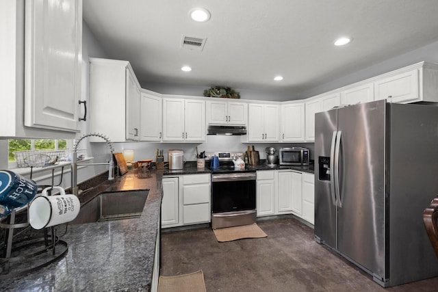 683 Cross Timbers, Livingston, TX 77351 - kitchen with stainless steel appliances, under cabinet range hood, concrete flooring, white cabinetry, and recessed lighting