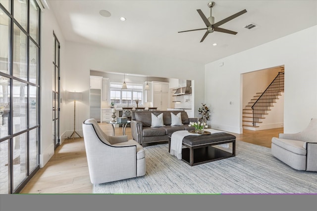 6626 Westchester Ave, West University Place, TX 77005 - living room with ceiling fan, light wood-style flooring, stairway, and recessed lighting
