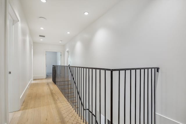 6626 Westchester Ave, West University Place, TX 77005 - hall featuring light wood-style flooring, recessed lighting, and an upstairs landing