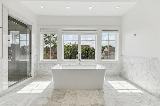 6626 Westchester Ave, West University Place, TX 77005 - bathroom with tile walls, a freestanding bath, marble finish floors, recessed lighting, and a stall shower