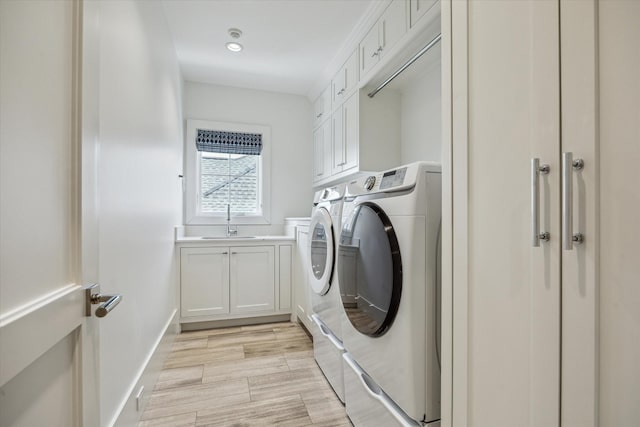 6626 Westchester Ave, West University Place, TX 77005 - laundry room featuring washing machine and dryer, cabinet space, light wood-style flooring, and recessed lighting