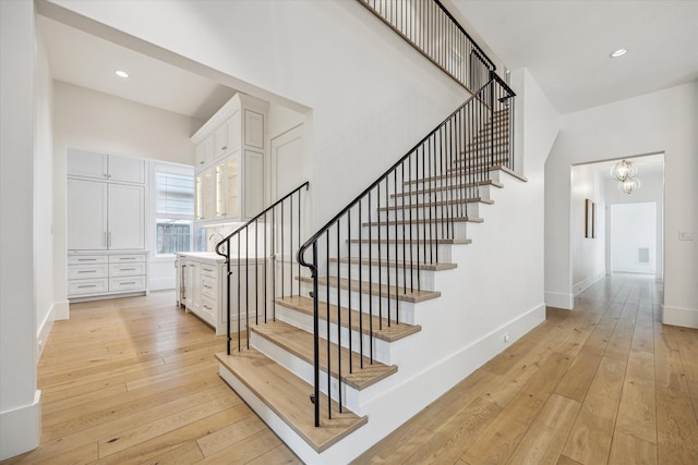 6626 Westchester Ave, West University Place, TX 77005 - stairway with hardwood / wood-style flooring, a chandelier, and recessed lighting