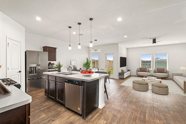 5122 Moonlit Garden Ln, Katy, TX 77449 - kitchen with appliances with stainless steel finishes, open floor plan, ceiling fan, dark brown cabinets, and light countertops