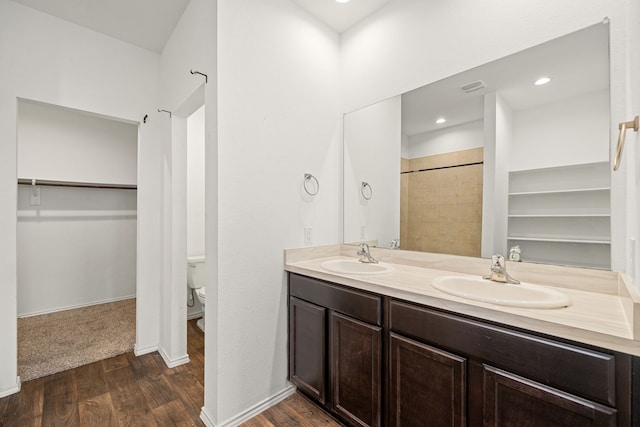 5122 Moonlit Garden Ln, Katy, TX 77449 - full bathroom with double vanity, wood finished floors, a walk in closet, and a shower